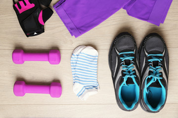 Sport equipment for woman  on wooden background