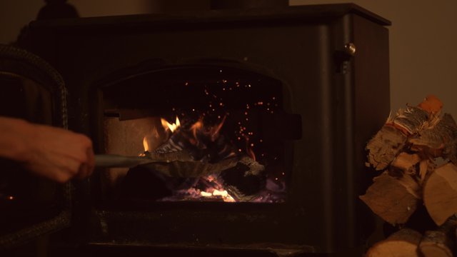 Putting logs in fireplace. Shot with high speed camera, phantom flex 4K.  Slow Motion. 