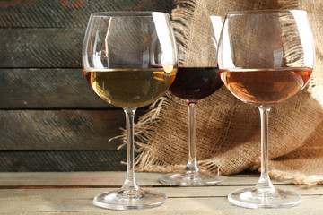 Composition of wine glasses on wooden background