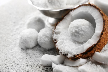 Homemade Candies in coconut flakes and fresh coconut on light background