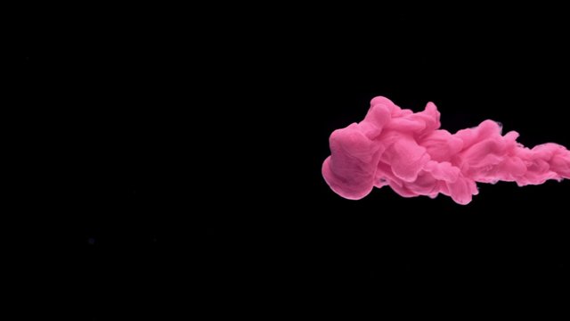 Close-up pink ink being poured into water. Shot with high speed camera, phantom flex 4K. Slow Motion. 