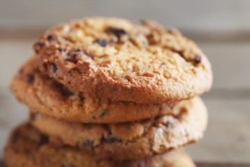 Cookies with chocolate crumbs on wooden table, close up