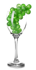 Clean wineglass with grapes, isolated on white