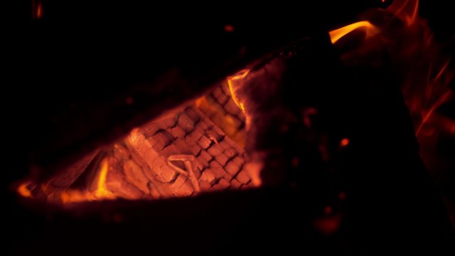 Burning logs in fire pit. Shot with high speed camera, phantom flex 4K. Slow Motion.