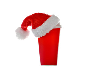 Obraz na płótnie Canvas Paper coffee cup with santa's hat on top isolated on white background