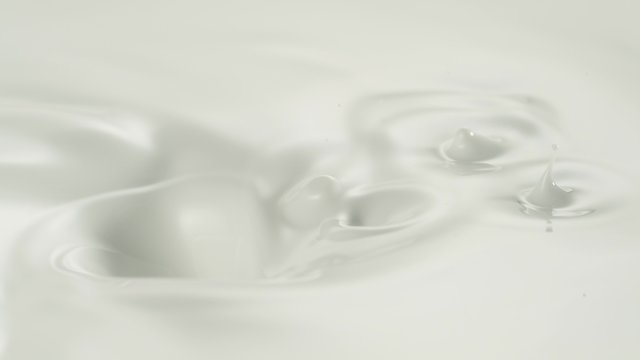 Pearls falling into cream swirl. Shot with high speed camera, phantom flex 4K.  Slow Motion. Unedited 