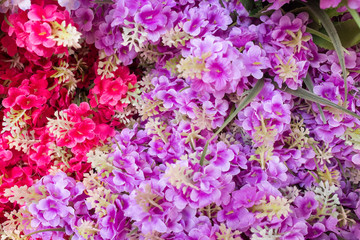 Colourful artificial flower made from plastic and fabric.