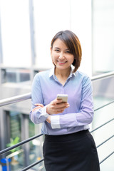 Asian businesswoman talking on a mobile phone at the office