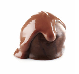 Chocolate poured on candy isolated on white
