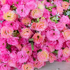 Colourful artificial flower made from plastic and fabric.