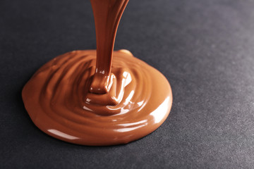 Chocolate poured on dark surface