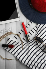 Striped fashion look on wooden background, close up