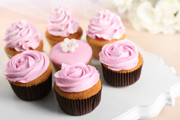 Tasty cupcakes on stand, close-up