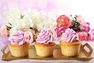 Tasty cupcakes on light background