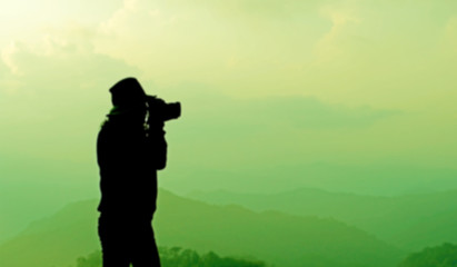 blurry silhouette photographer is taking photos