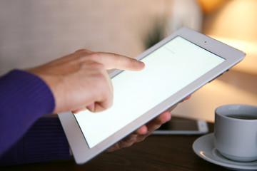 Young man using his tablet-pc, close up