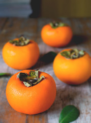 persimmon on rustic wooden background