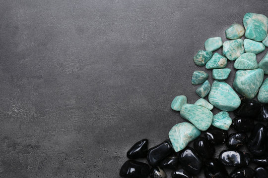 Frame of black onyx and azonite on grey background, copy space