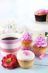 Tasty cupcakes on tray, on light background