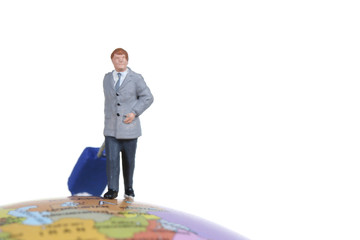 A miniature businessman standing on earth, isolated on white bac