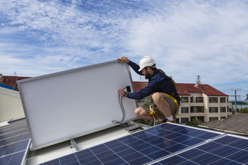 Solar panel technician checking solar panels