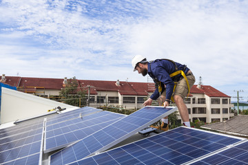 Solar panel technician installing solar panels