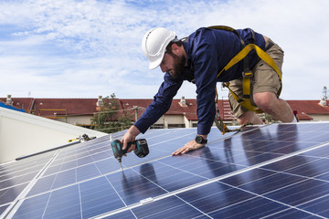 Solar panel technician with drill