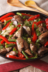 Braised Chicken liver with onion and pepper close-up. vertical
