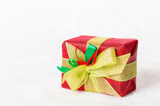 Red Christmas gift box on white background.