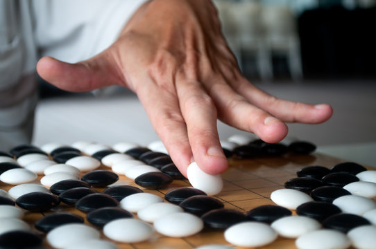 White Go player making his move