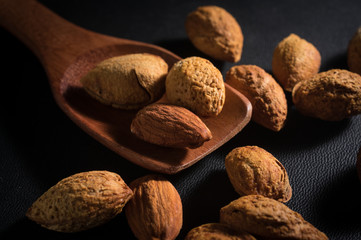 Almonds nut on wood spoon.
