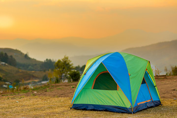 tent in the sunset overlooking mountains and a valley