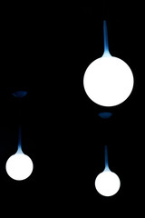 Lit spherical lamps with blue stem on dark