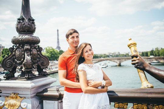 couple of tourists taking photo with Eiffel Tower in Paris,  tourism in Europe, France