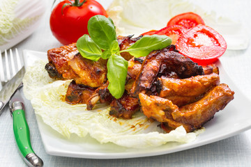 Grilled pork ribs served on a platter. Step on step recipe.