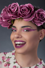 Close-up portrait  girl with a pink lipstick and shadows for eyes and a wreath on his head