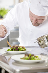 Professional chef prepare meat dish at restaurant