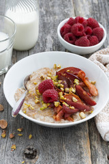 oatmeal with baked fruit and pistachios for breakfast, vertical