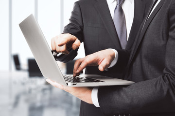 Businessmen with laptop in office