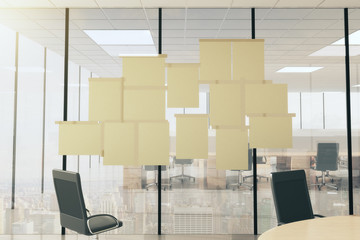 Blank paper posters on vtireous wall in modern office with furni