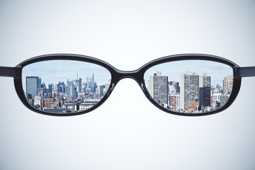 Clear vision concept with eyeglasses with megapolis city at whit