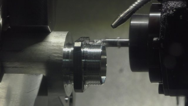 CNC milling machine makes some steel part on a factory, ULTRA HD 4K, real time, zoom