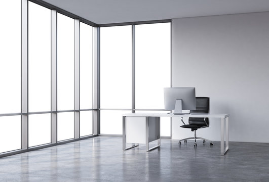 A workplace in a modern corner panoramic office with copy space in the windows. A white desk with a modern computer, black leather chair. A concept of consulting services. 3D rendering.