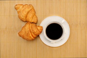 Cup of coffee with croissant. Top view