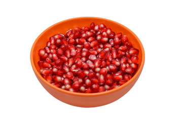 pomegranate seeds in orange plate isolated on white