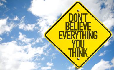 Don't Believe Everything You Think sign with sky background