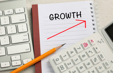 concept of growth, with calculator and desk background