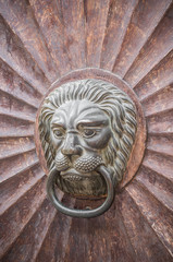 lion shaped knocker on the old wooden door