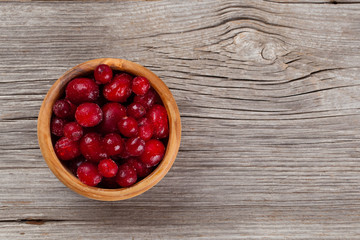 frozen cowberries on wooden background