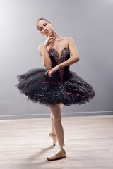  Ballerina is wearing a white tutu and pointe shoes © V&P Photo Studio